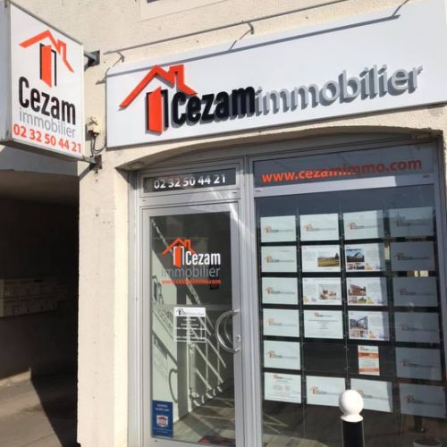 Pose adhésifs découpés sur façade agence immobilière